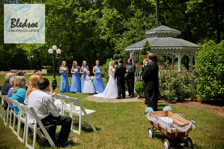 Bridal party standing at gazebo at Dara's Garden.