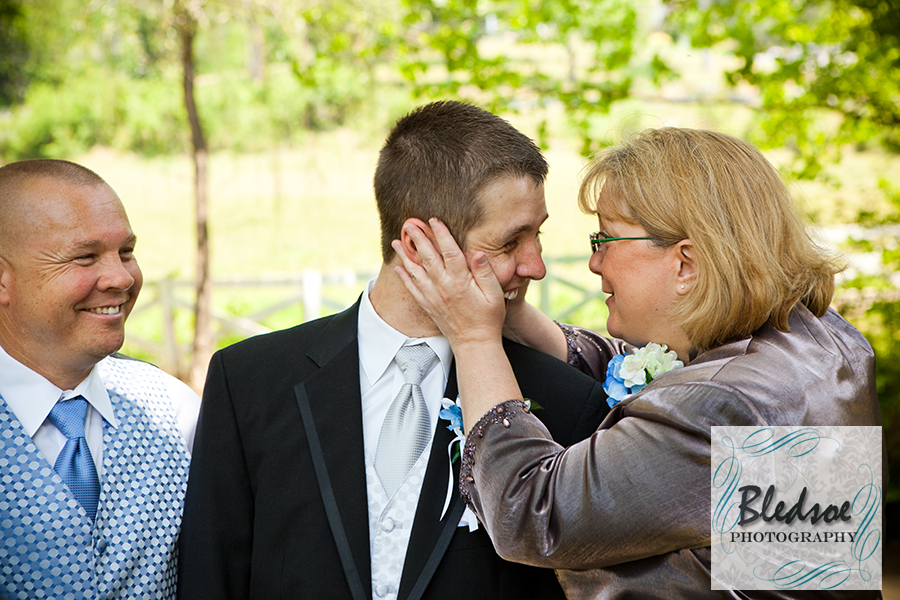 Groom's mother squeezing his cheeks at Dara's Garden.