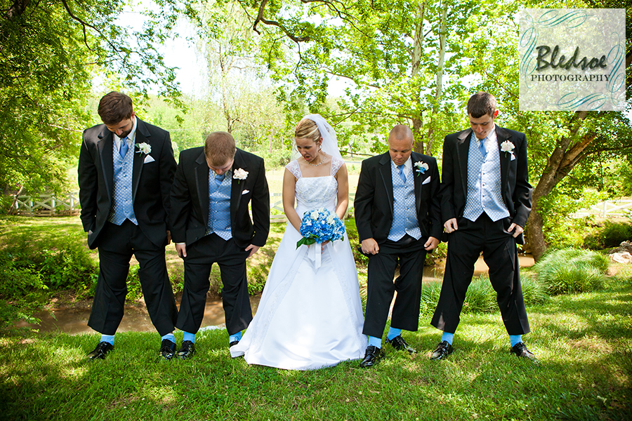 Bride's reaction to seeing groomsmen's Carolina blue socks at Dara's Garden.