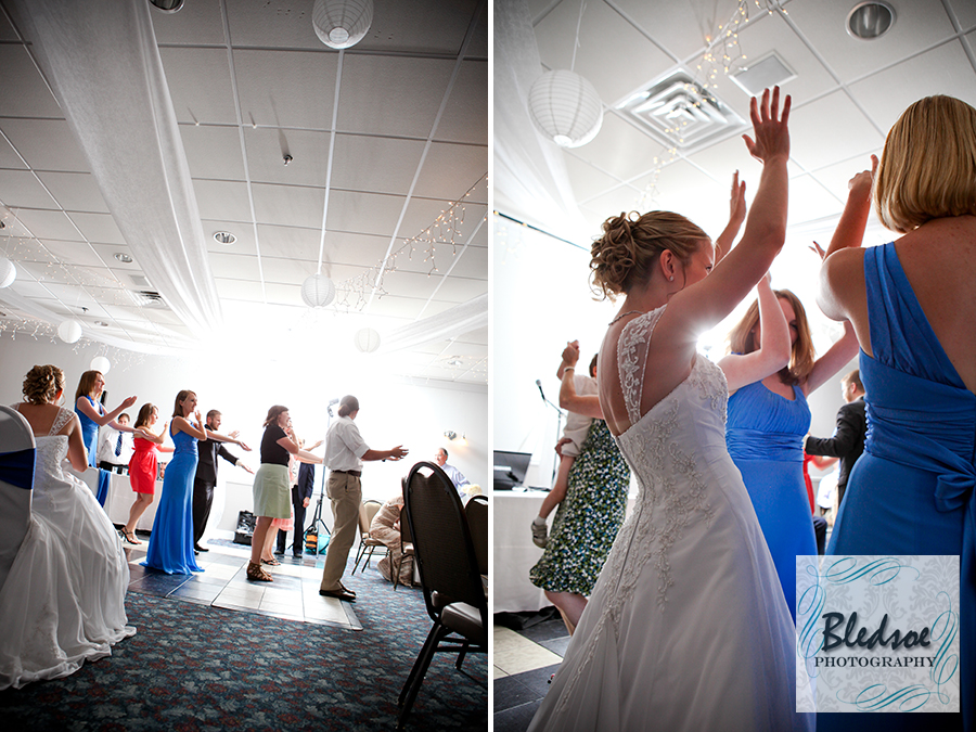 Bride and guests dancing at wedding reception at Rothchild Catering Center.