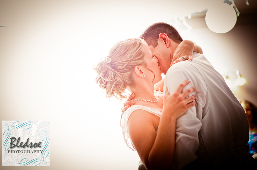 Bride and groom's last dance kiss at wedding reception at Rothchild Catering Center.