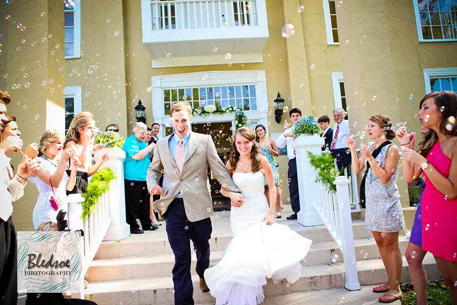 Couple running through bubbles. Wedding at The Dent House in Chattanooga, TN. © Bledsoe Photography