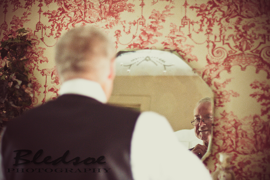 Father of the bride dressing in mirror at Glenmore Mansion wedding. Knoxville Wedding Photographer. © Bledsoe Photography