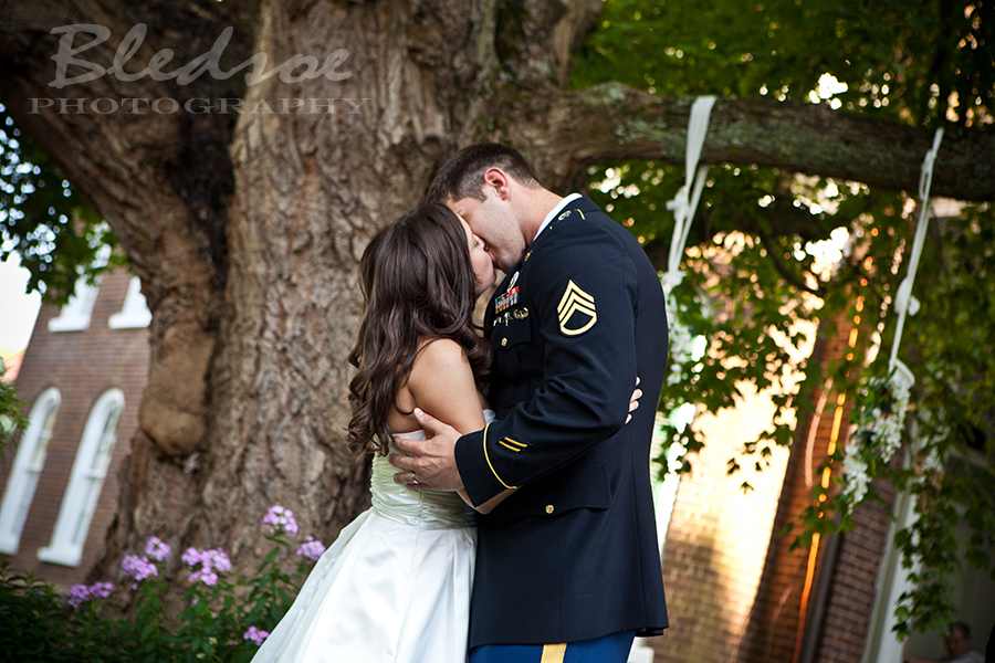Bride and Marine groom's first kiss as husband and wife at Glenmore Mansion wedding. Knoxville Wedding Photographer. © Bledsoe Photography