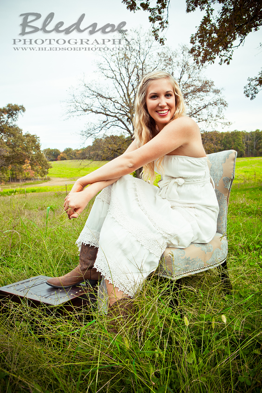 sarah bounds outdoor farm field inside tractor wheel country senior portraits photos in knoxville Bledsoe Photography