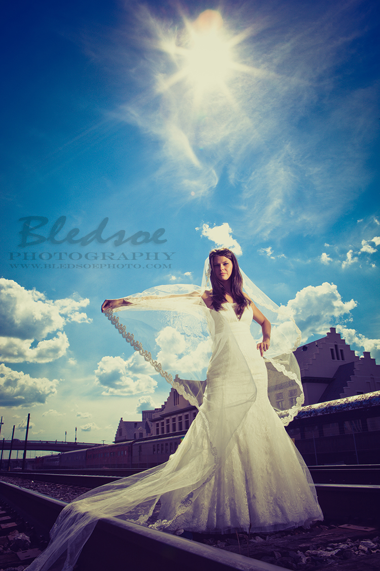 Bride on train tracks, Knoxville after wedding portrait session, © Bledsoe Photography