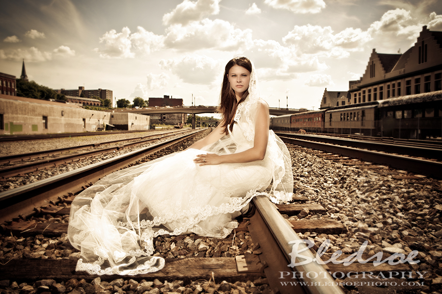 Bride on train tracks, Knoxville after wedding portrait session, © Bledsoe Photography