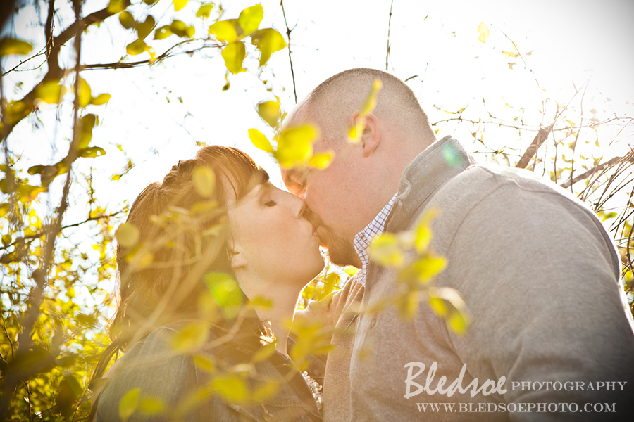 Engagement photo session at Melton Hill Lake, kiss through the trees, © Bledsoe Photography