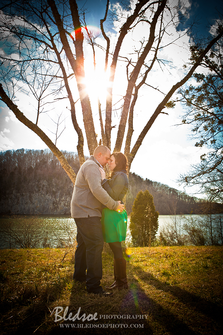 Engagement photo session at Melton Hill Lake, emerald green dress, sun through the trees © Bledsoe Photography