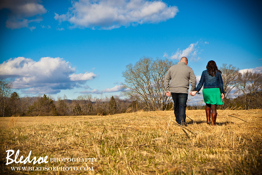 Engagement photo session at Melton Hill Lake, holding hands, emerald green dress and bright blue sky, © Bledsoe Photography