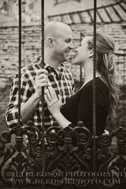 Knoxville engagement photo session at Barley's in the Old City, couple behind iron gate © Bledsoe Photography