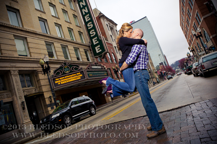 Knoxville engagement photo session in the Old City, couple kissing in the street in front of the Tennessee Theatre © Bledsoe Photography