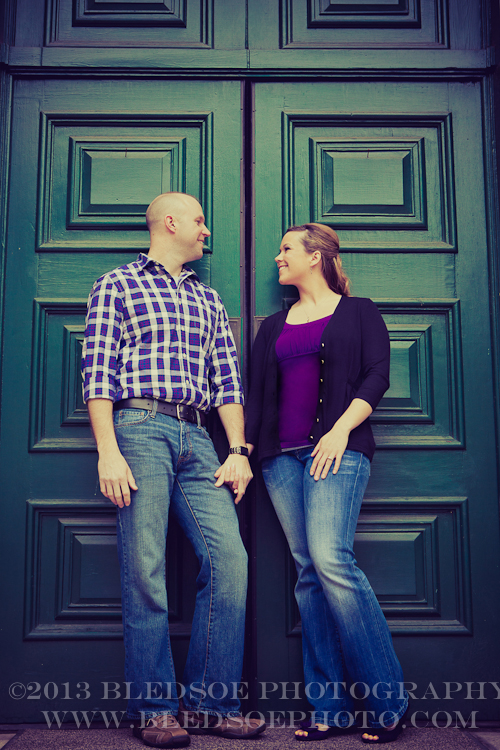 Knoxville engagement photo session in the Old City, couple holding hands in front of a green door © Bledsoe Photography