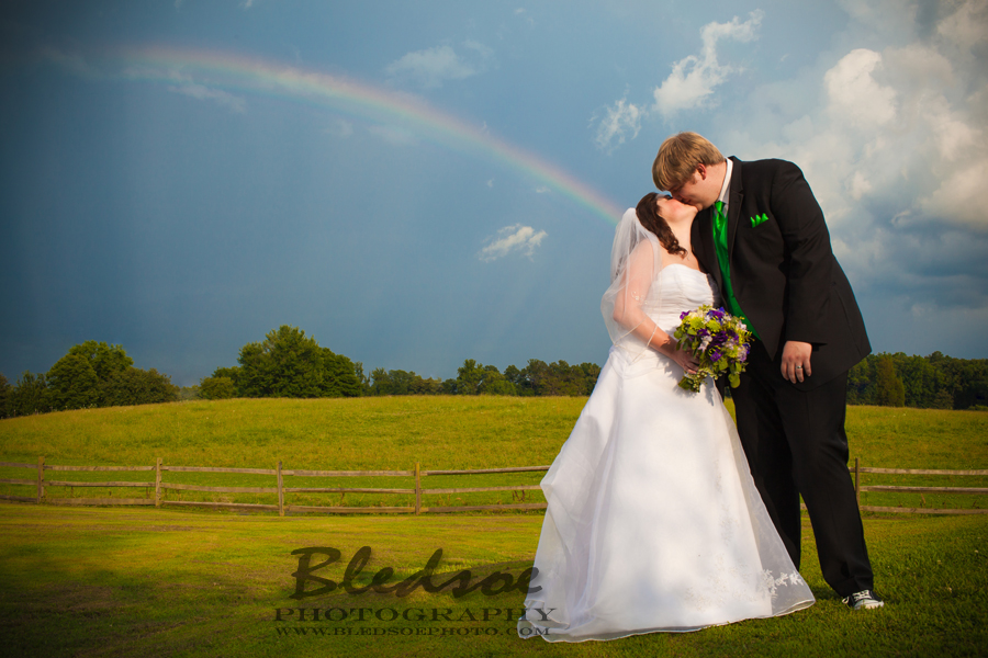 Rainbow over bride and groom after wedding ceremony at Twin Cedar Farm