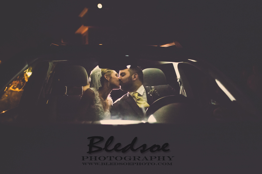 bride and groom kiss in getaway car, knoxville wedding photography photographer