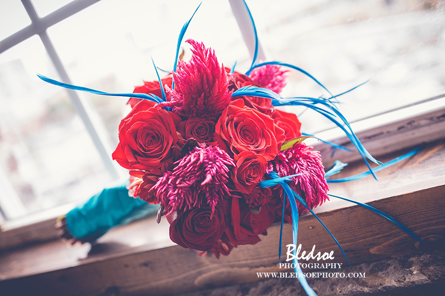 nashville-wedding-cannery-one-turquoise-feathers-red-rose-bouquet