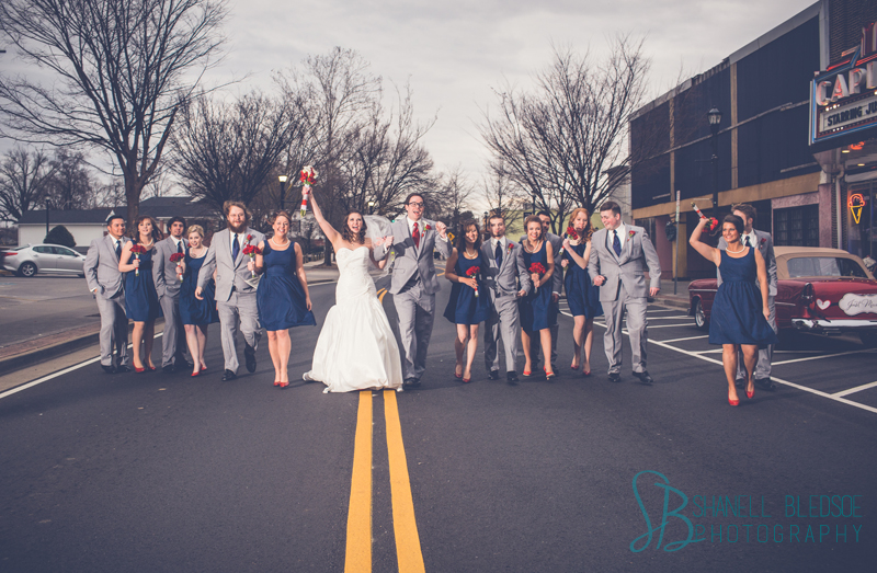 Old Hollywood glam art deco wedding at Capitol Theatre in Maryville, TN. Navy, red, gray wedding colors, wedding party walking in street