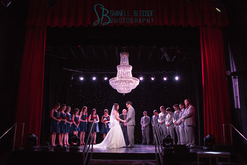Old Hollywood glam art deco wedding at Capitol Theatre in Maryville, TN. Ceremony on stage, crystal chandelier