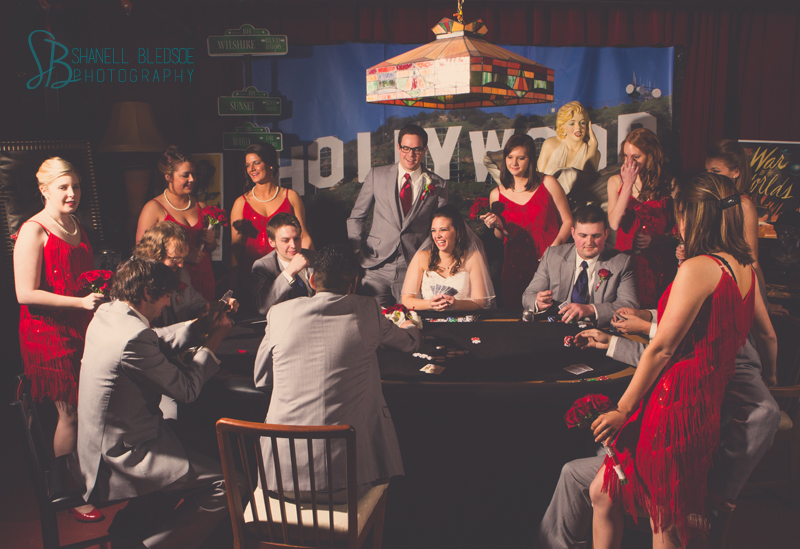 Old Hollywood glam art deco wedding at Capitol Theatre in Maryville, TN. Wedding party playing poker in man cave speakeasy, flapper bridesmaid