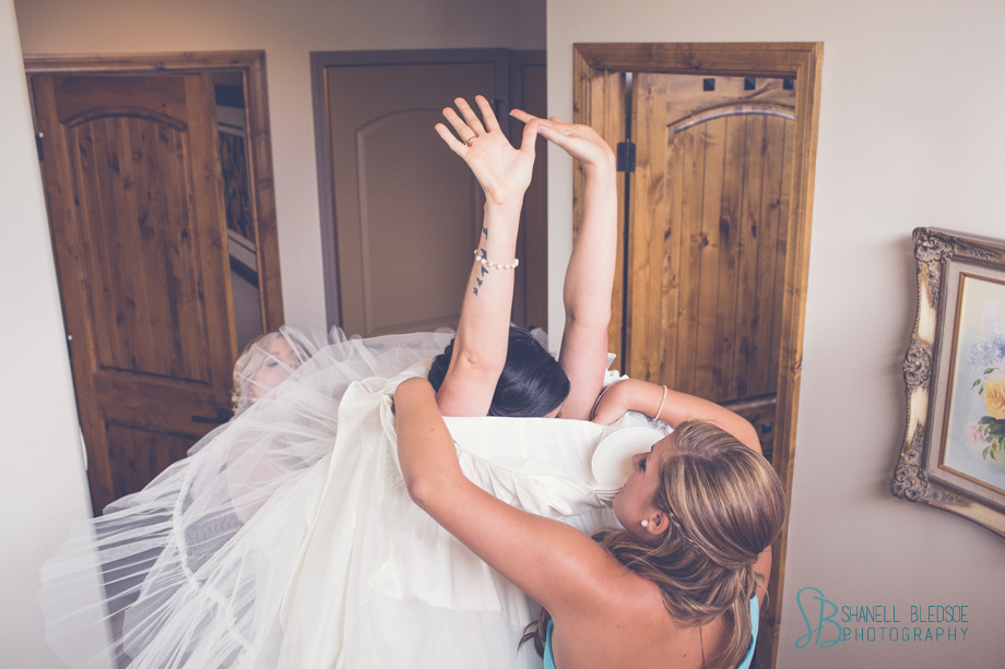 bride putting dress over her head. Alfred Angelo 2469, shanell bledsoe photography