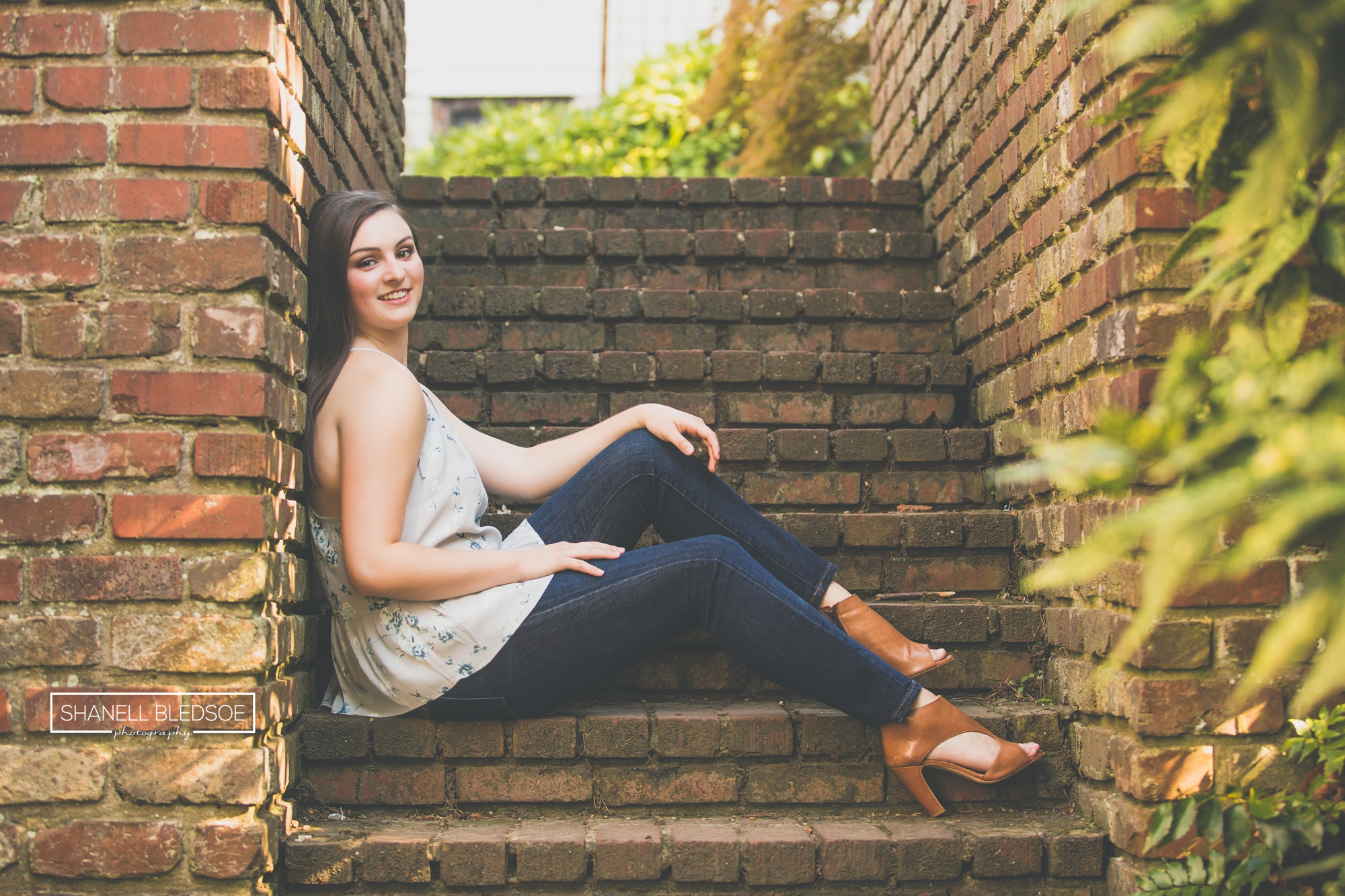 Casual senior portrait girl sitting on brick stairs
