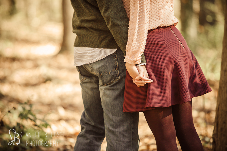 Fall autumn engagement photo session at Ijams Nature Center in Knoxville, TN by Shanell Bledsoe Photography. Holding hands in the woods.