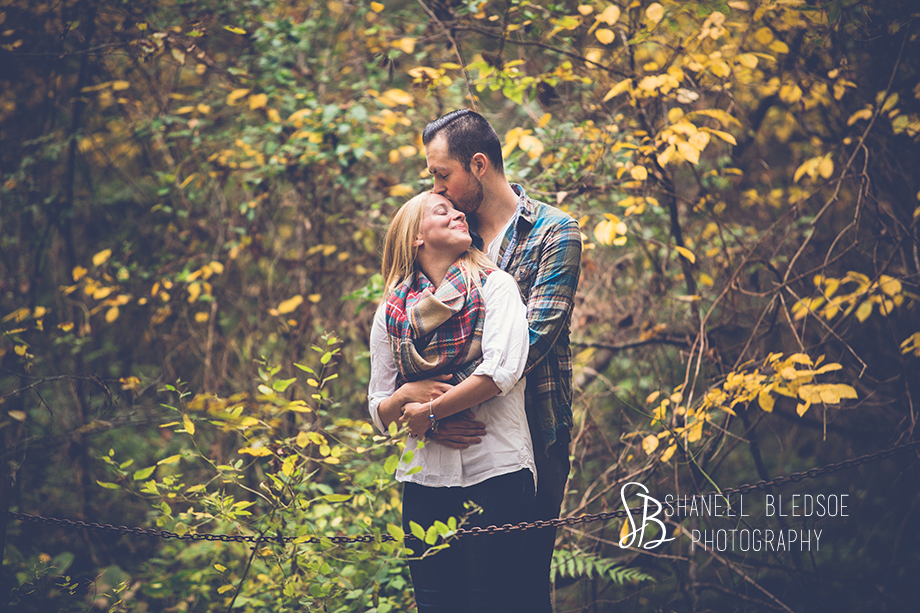 couple kissing at Lotus Pond. Shanell Bledsoe Photography, autumn engagement photos at Ijams Nature Center, Knoxville