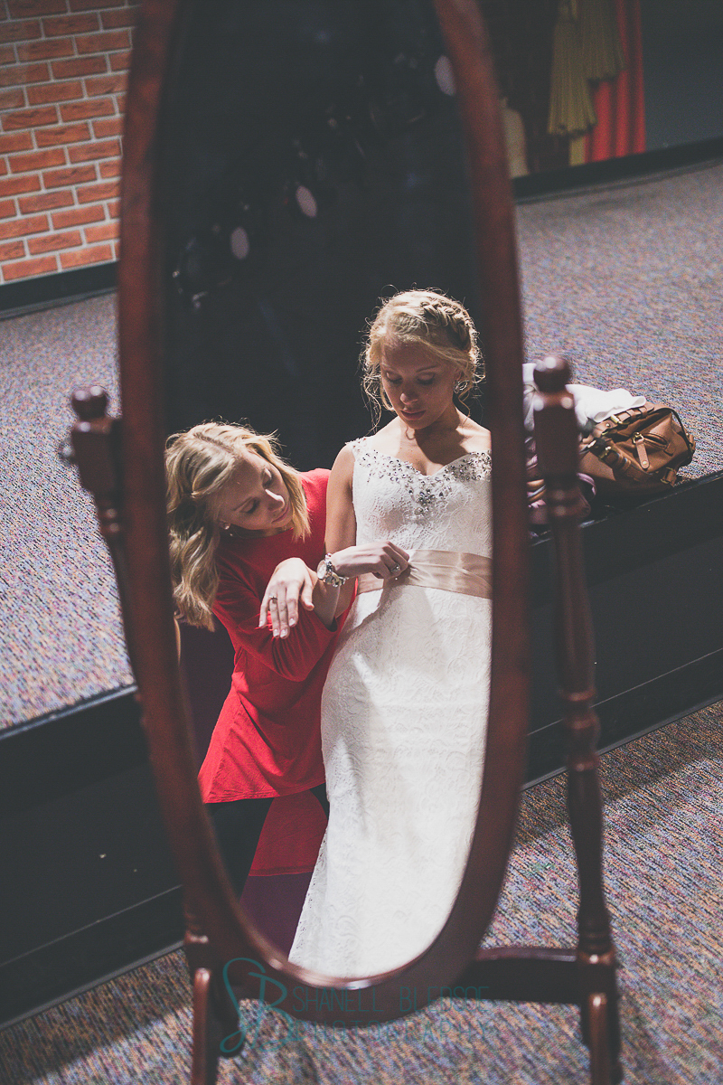 Mirror reflection of bride and sister