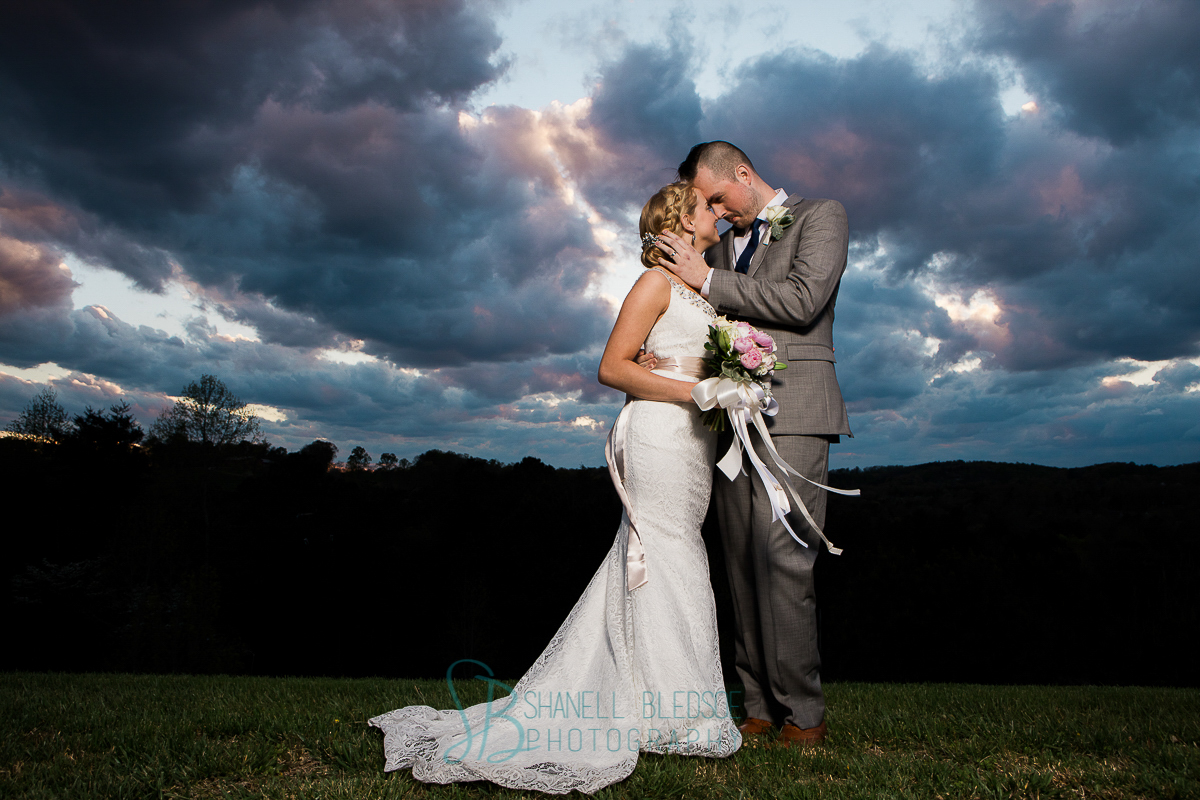 Bride and groom at beautiful sunset, mountaintop 