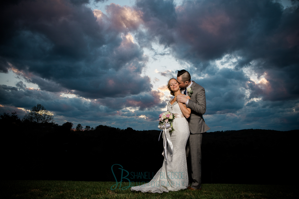Bride and groom at beautiful sunset, mountaintop 