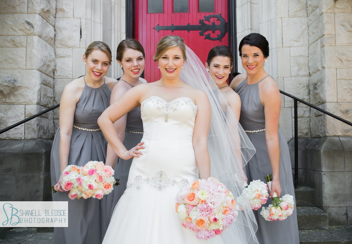 Bride and bridesmaids in front of red door, st. john's lutheran church, knoxville