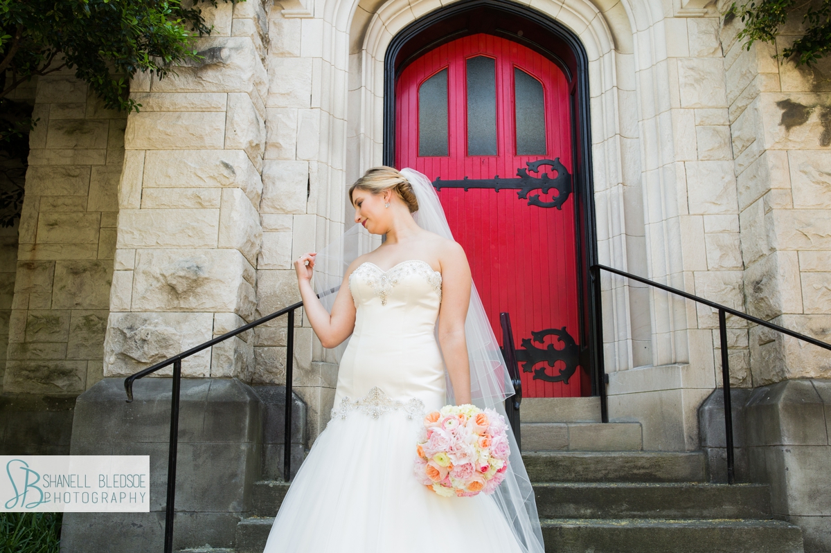 Bridal portrait in front of red door, st. john's lutheran church, knoxville