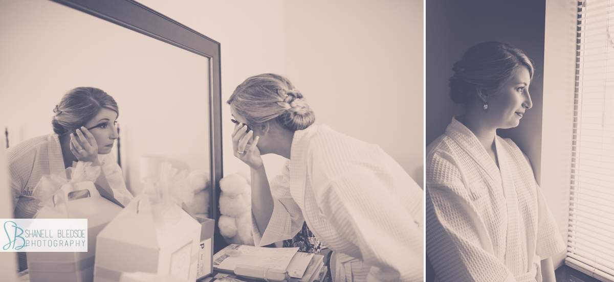Bride in white robe putting on makeup in mirror, window, knoxville wedding photographer