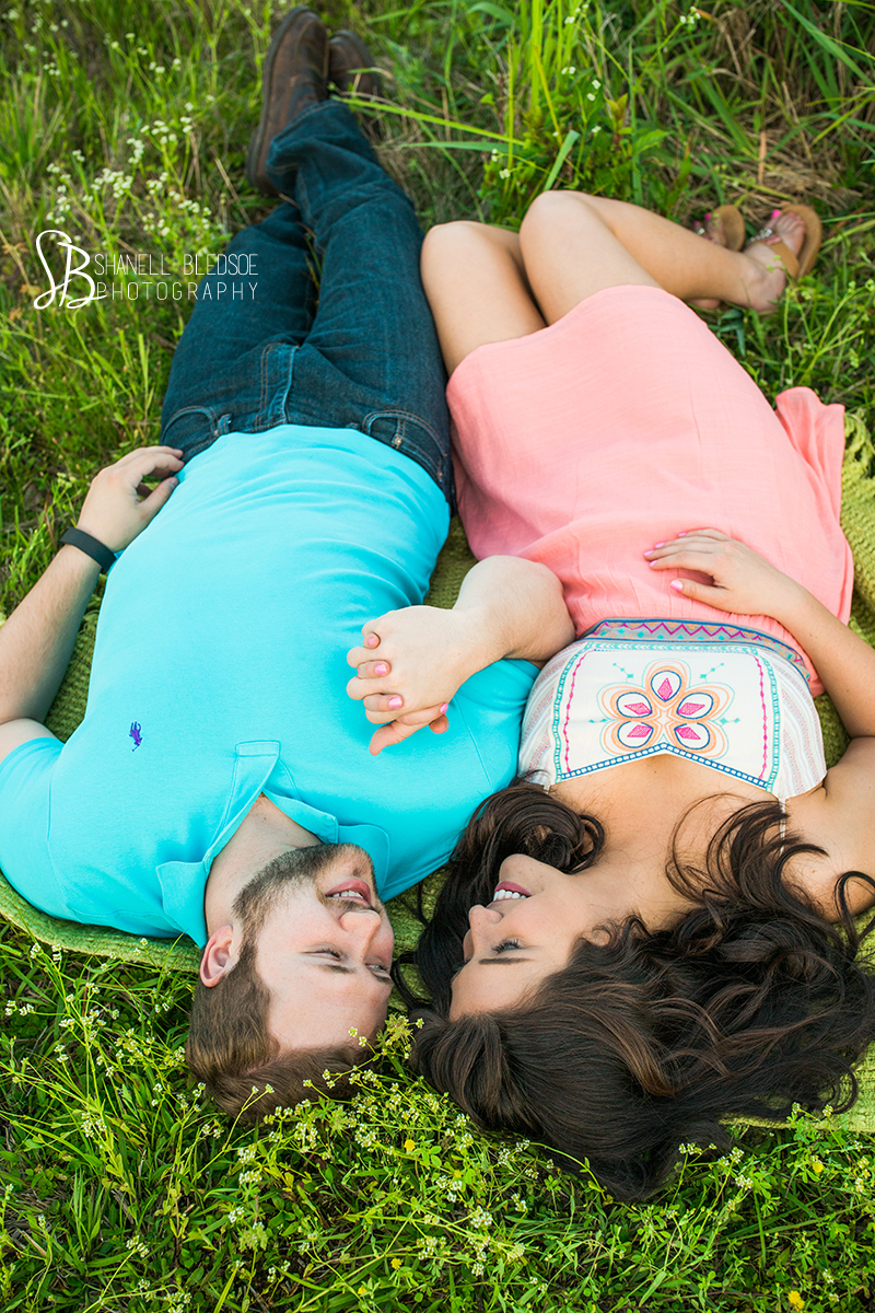 lying in the grass, lake, engagement, photos, white pine, knoxville, tn, couple