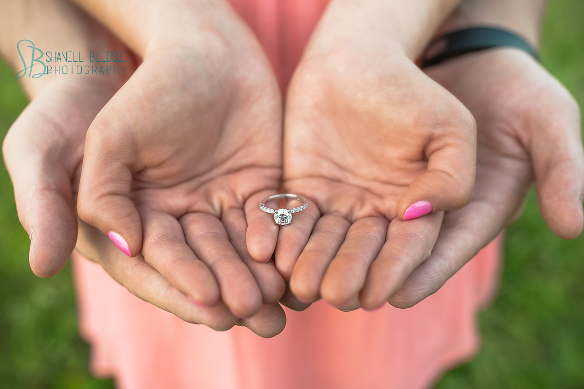 diamond engagement in couple's hands