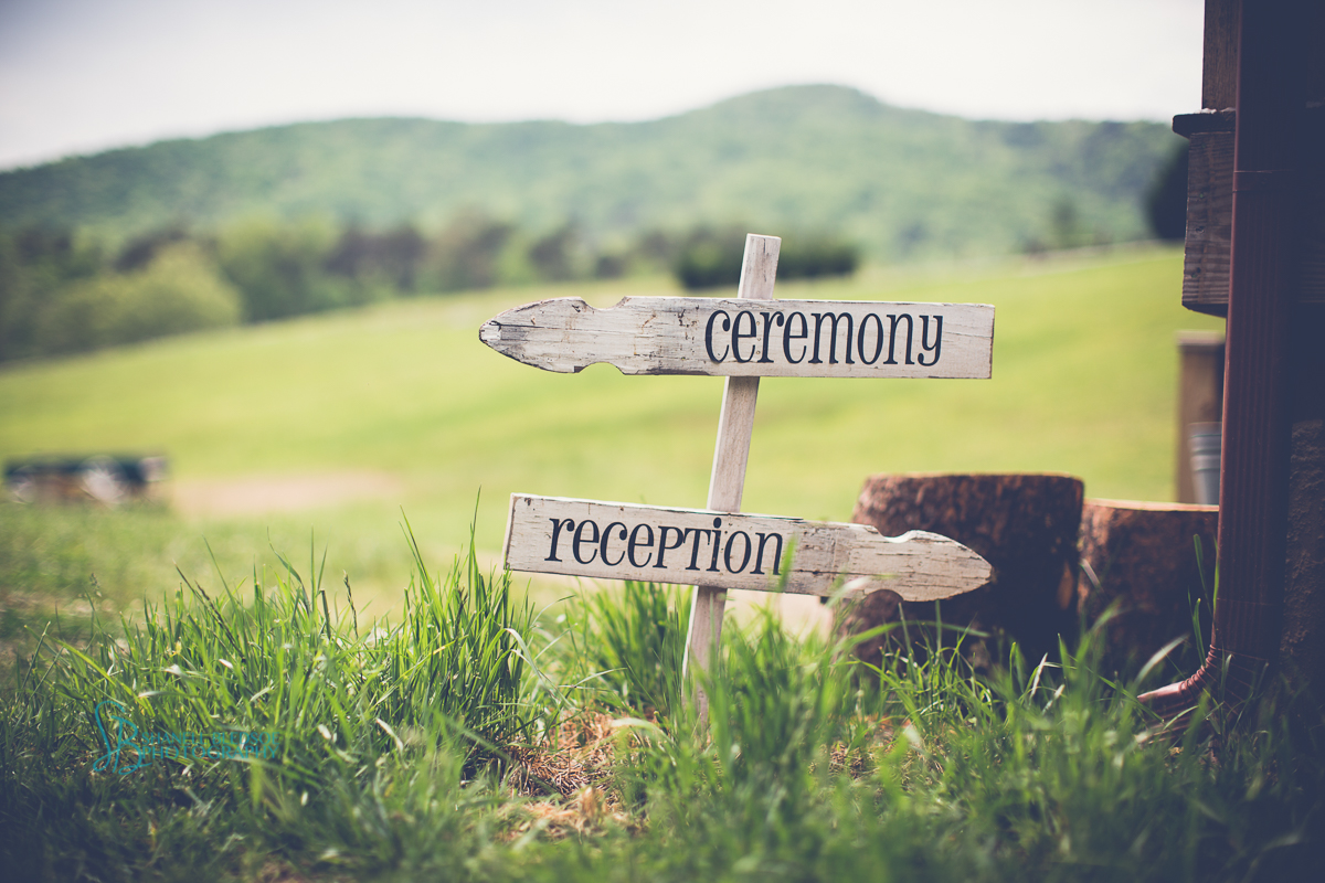 Rustic arrow signs to ceremony and reception
