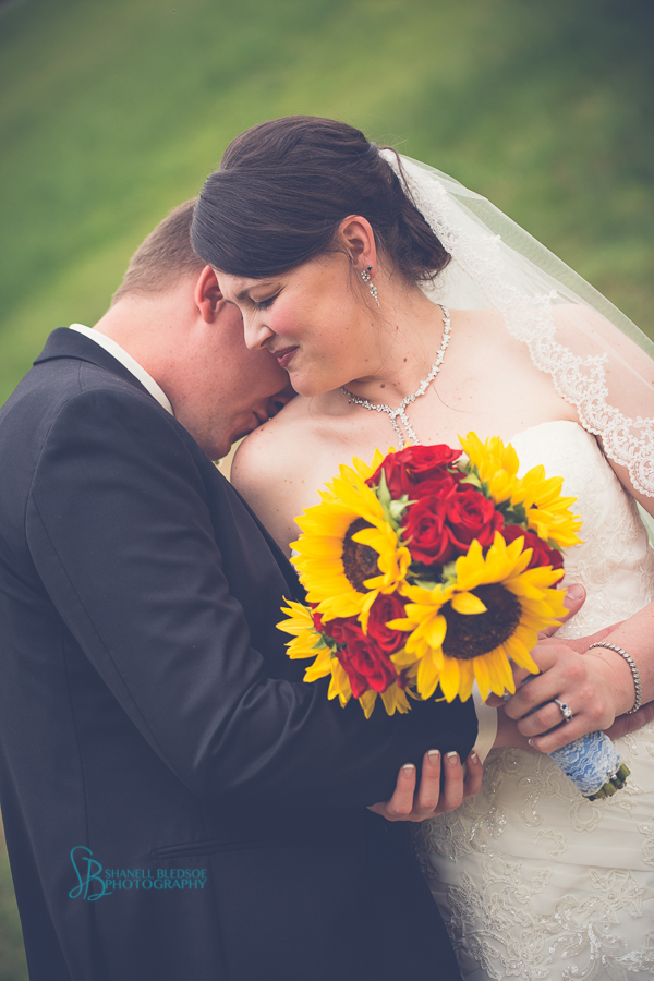 bride and groom at sampson's hollow, sunflower and red rose bouquet