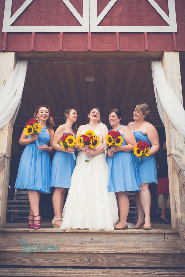bride and bridesmaids in cornflower blue dress at sampson's hollow, sunflower and red rose bouquet