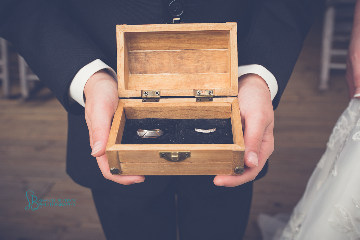 ringbearer holding wedding rings in custom wood box
