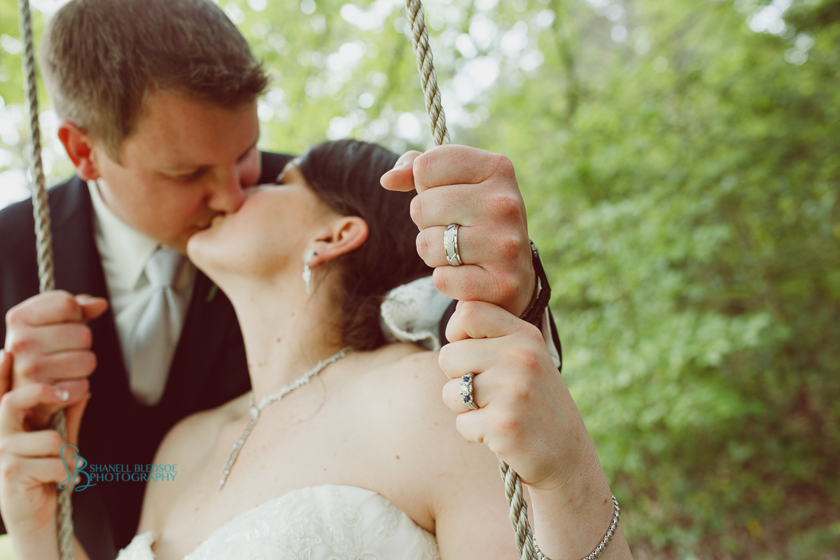 bride and groom on tree swing, ring close up