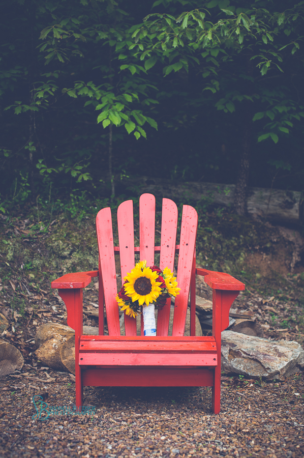 bridal bouquet sunflowers and red roses in red adirondack chair