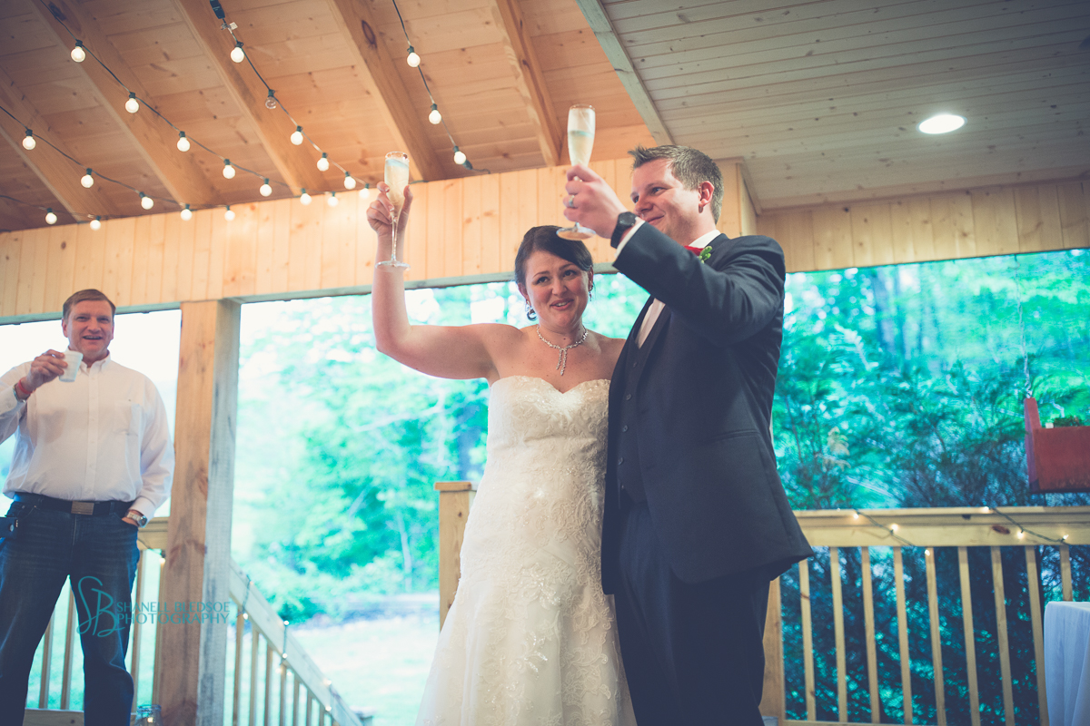 bride and groom toast barn wedding reception