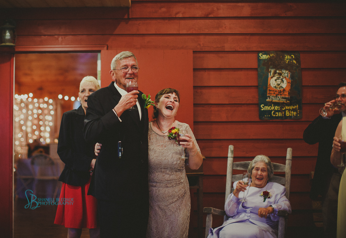 parents toast red barn wedding reception