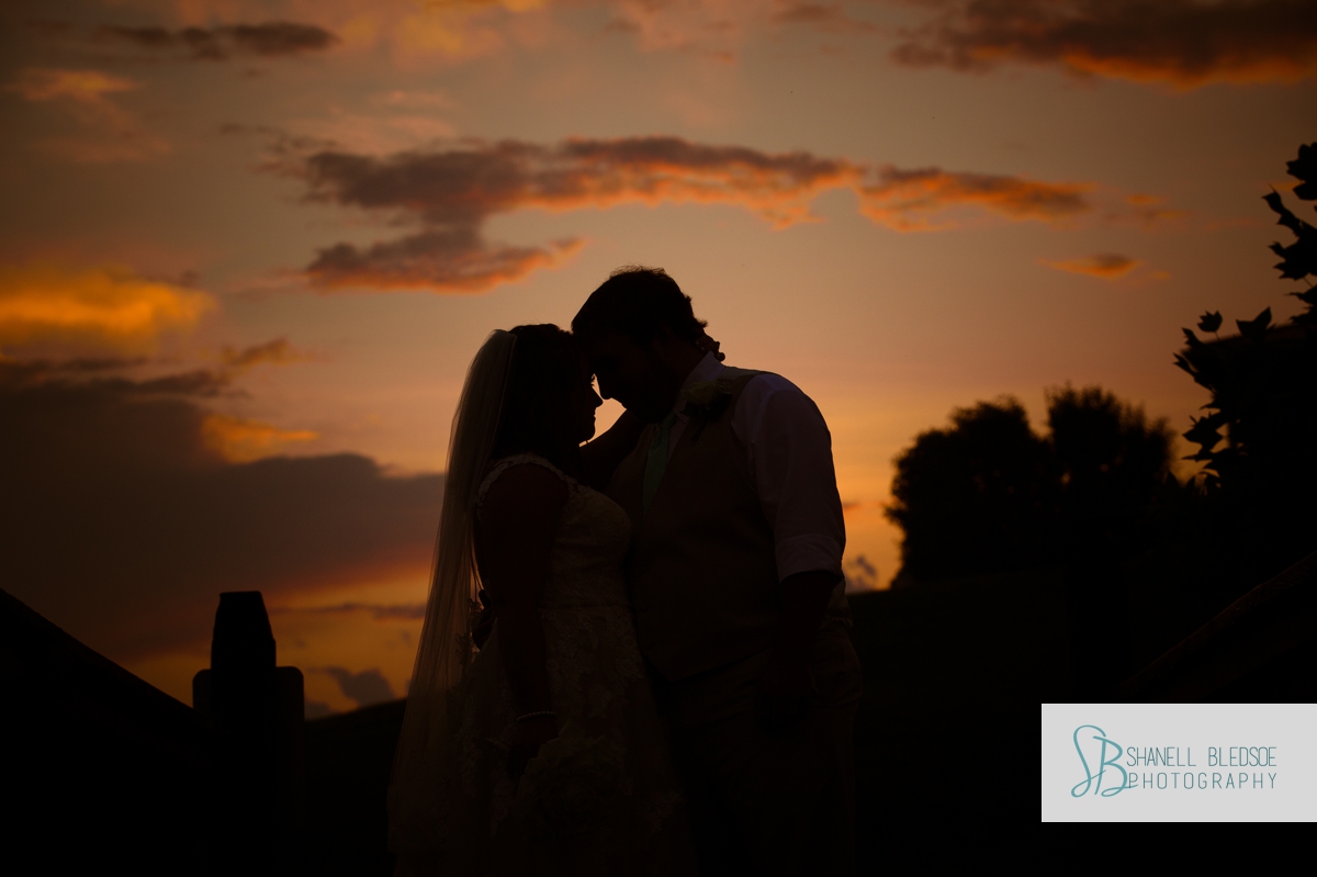 sunset-silhouette-orange-sky-bride-and-groom-wedding