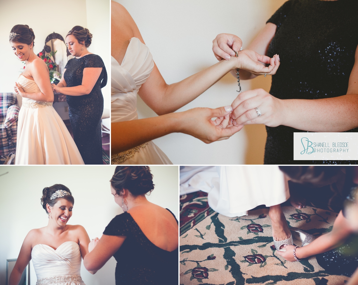 Bride and sister putting on wedding dress and jewelry