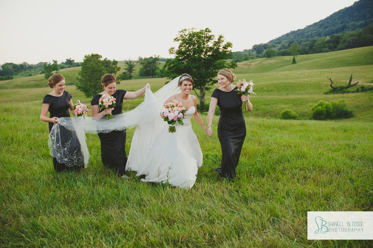 Bride and bridesmaids walking in a Tennessee mountain field, LaFollette, TN wedding photographer, shanell bledsoe photography