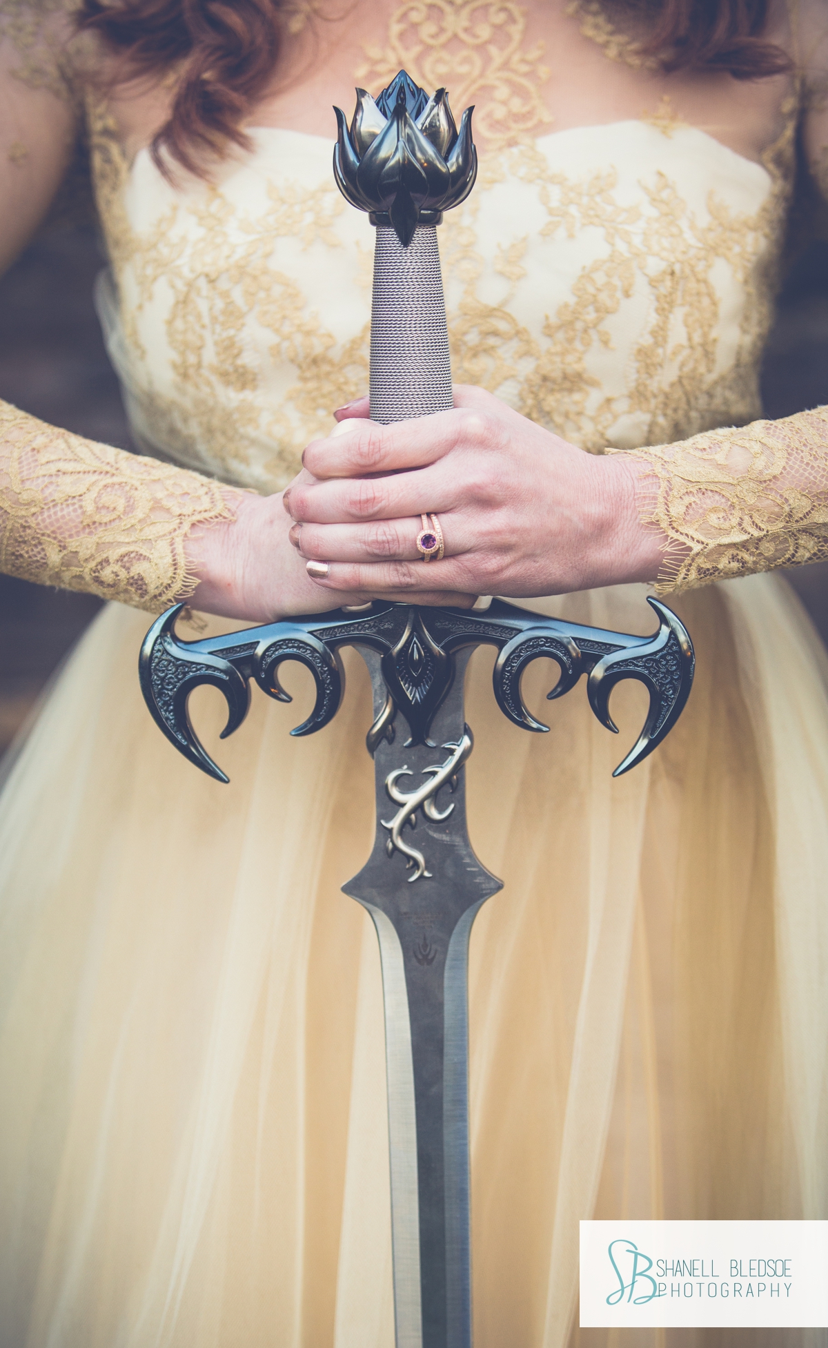game of thrones theme wedding inspiration, gold lace dress, sword in ladies hands