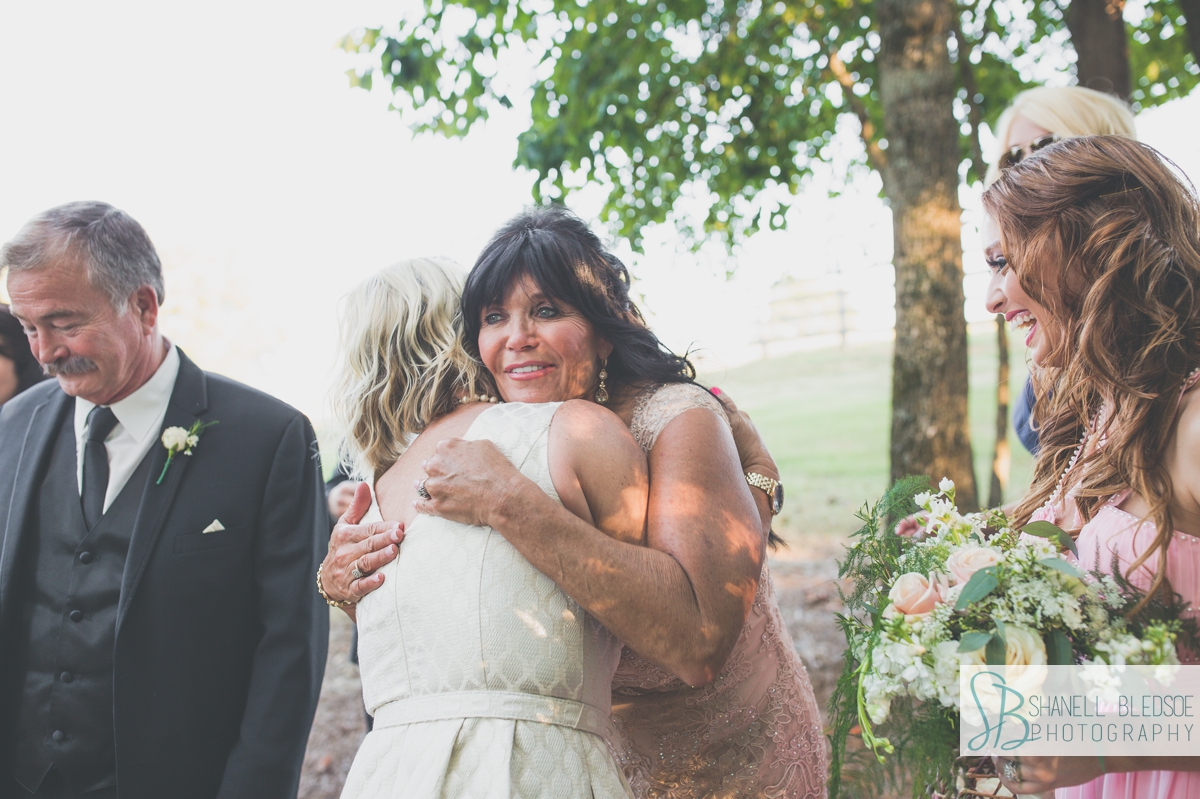 mothers of bride and groom hugging