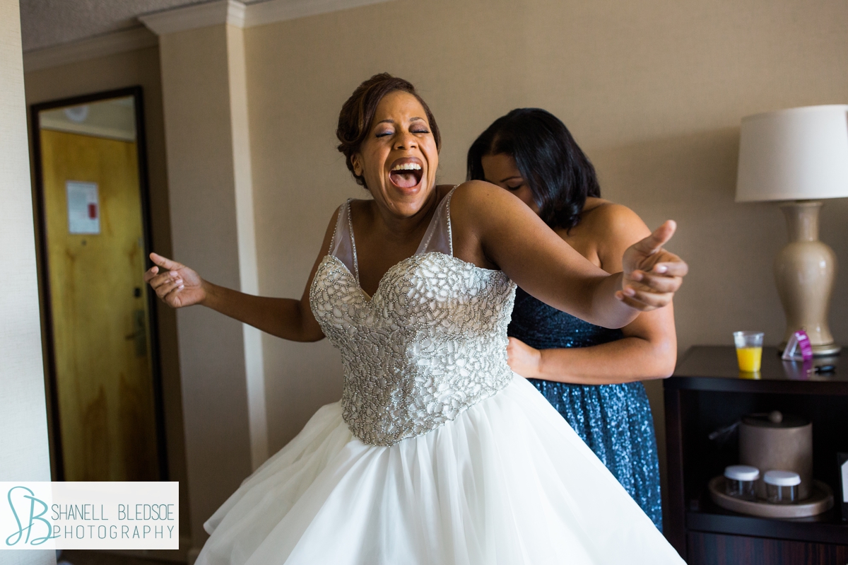 Bride getting dressed at Crowne Plaza Knoxville wedding