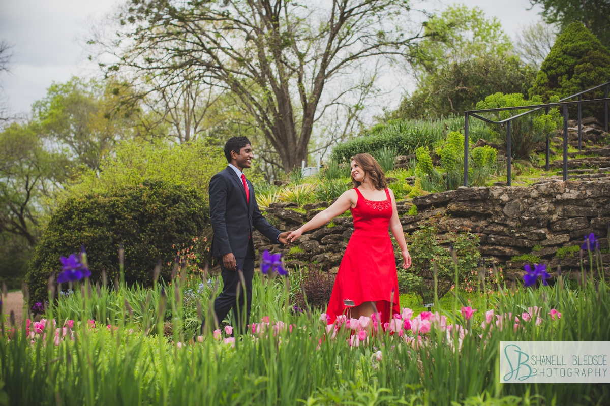 Bride leading groom through Wills Perennial Garden at Cheekwood